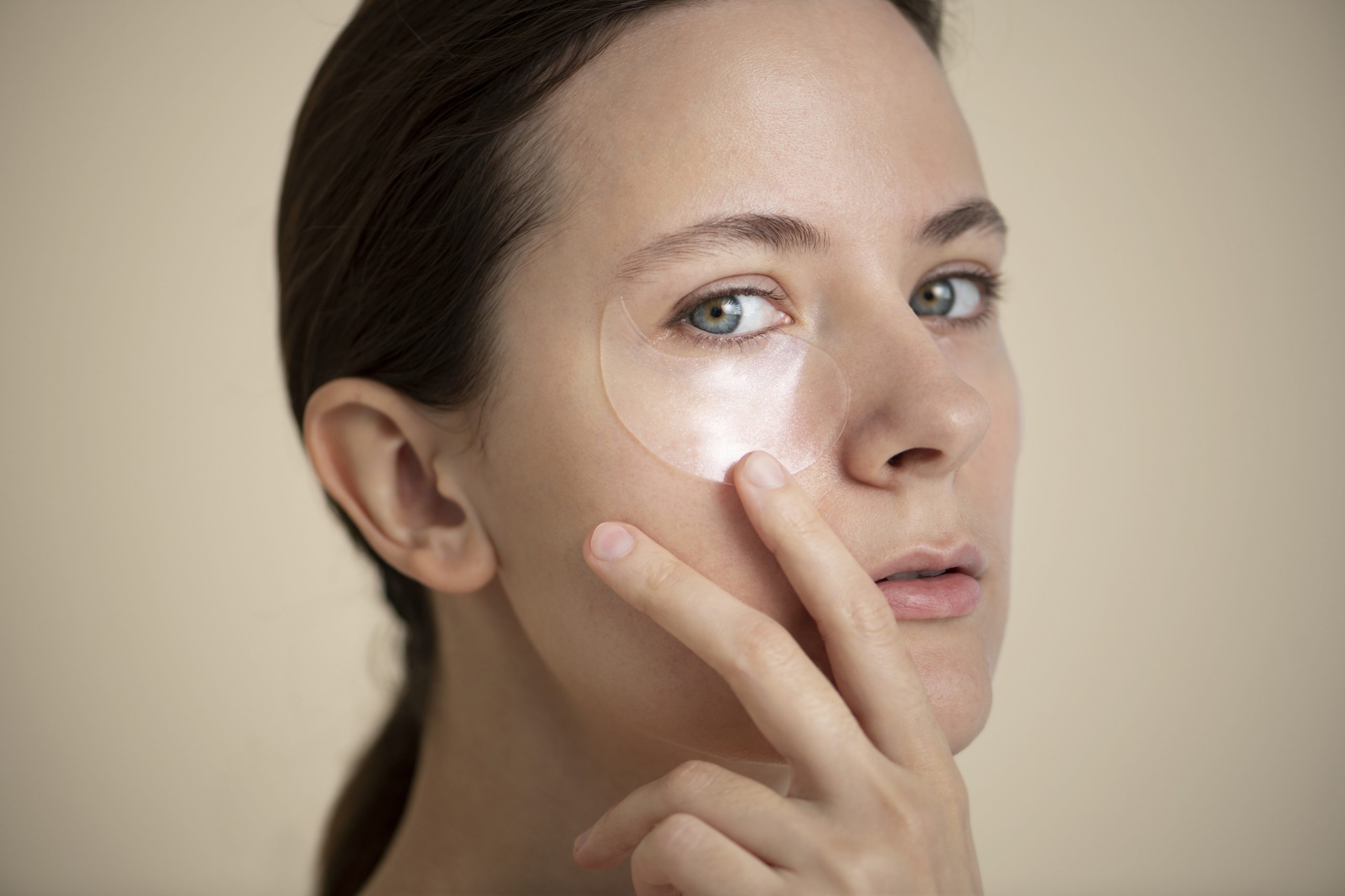 Woman using dermocosmetic patches